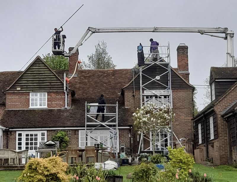 The Roof Moss Cleaners using cherry picker and scaffolding to clean roof safely and professionally in Winslow, Buckinghamshire