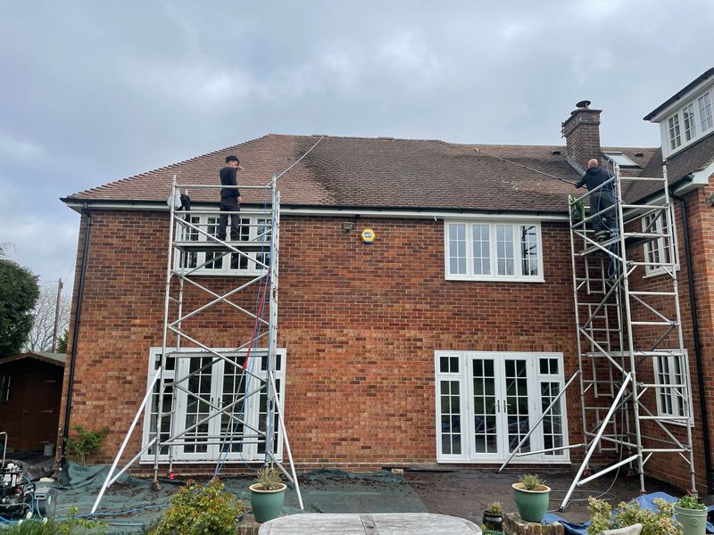 Roof cleaning carried out safely from scaffold towers by The Roof Moss Cleaners in Winslow